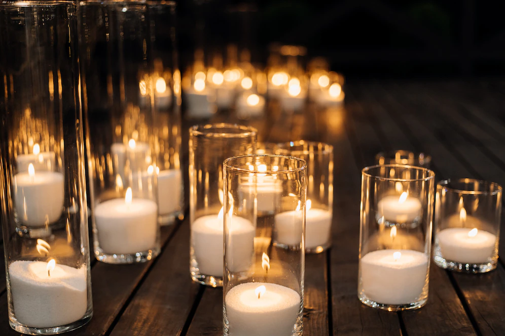 burning candles in transparent glass