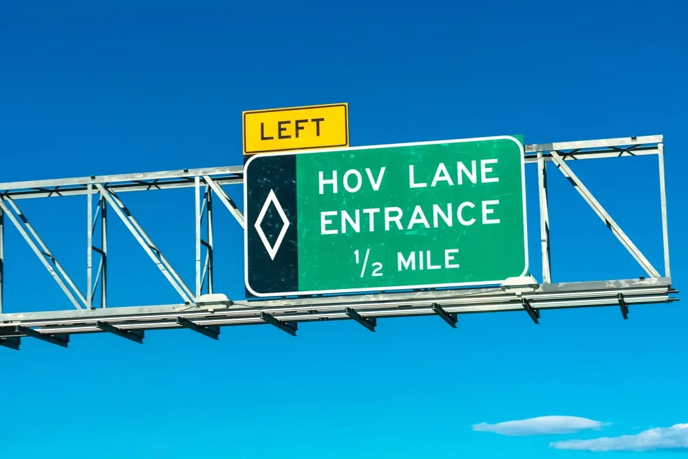 A closeup photo of an HOV lane entrance sign